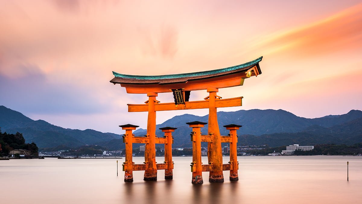 Hiroshima, Japan - December 3, 2015: The floating torii gate of Itsukushima Shrine. The gate, which acts as a boundary between the spirit world and the human world, is said to be 500 to 600 years old.